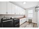 Bright laundry room with built-in cabinets and countertop at 324 Patternote Rd, Mooresville, NC 28117