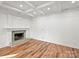 Bright basement with a stone fireplace and hardwood floors at 3453 Selwyn Ave, Charlotte, NC 28209