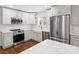 Modern kitchen with white cabinets, farmhouse sink, and stainless steel appliances at 3453 Selwyn Ave, Charlotte, NC 28209