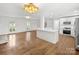 Open concept kitchen with island, stainless steel appliances, and hardwood floors at 3453 Selwyn Ave, Charlotte, NC 28209