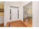 Bright entryway with hardwood floors, a white door and views into the adjacent living room at 355 Sardis Rd N Alt Rd, Charlotte, NC 28270