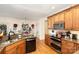 Modern kitchen with granite countertops, wood cabinets, and stainless steel appliances at 355 Sardis Rd N Alt Rd, Charlotte, NC 28270