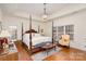 Main bedroom with hardwood floors, a four-poster bed, and a sitting area at 355 Sardis Rd N Alt Rd, Charlotte, NC 28270