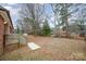 Spacious backyard with mature trees and a wooden deck at 4201 Westridge Dr, Charlotte, NC 28208