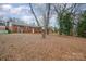 Large backyard with mature trees and a brick home at 4201 Westridge Dr, Charlotte, NC 28208