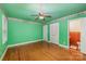 Bedroom with hardwood floors, ceiling fan and access to a half bathroom at 4201 Westridge Dr, Charlotte, NC 28208