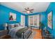 Bedroom with blue walls, hardwood floors, and a window at 4201 Westridge Dr, Charlotte, NC 28208