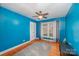 Blue bedroom with hardwood floors and ceiling fan at 4201 Westridge Dr, Charlotte, NC 28208