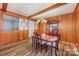 Dining room with wood paneling and hardwood floors at 4201 Westridge Dr, Charlotte, NC 28208