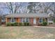 Brick ranch house with landscaped lawn and walkway at 4201 Westridge Dr, Charlotte, NC 28208