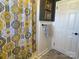 Updated bathroom with patterned shower curtain and wainscoting at 511 W Stevens Dr, Kershaw, SC 29067