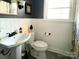 Clean bathroom with pedestal sink, toilet and window at 511 W Stevens Dr, Kershaw, SC 29067