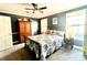 Comfortable bedroom with a double bed, dark blue walls, and ceiling fan at 511 W Stevens Dr, Kershaw, SC 29067