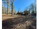 Lovely front lawn view of a home with a red brick chimney and mature trees on a sunny day at 511 W Stevens Dr, Kershaw, SC 29067