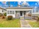 Charming white bungalow with front porch and landscaped yard at 526 S Green St, Statesville, NC 28677