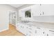 Kitchen boasts white cabinets, granite countertops, and light wood floors at 526 S Green St, Statesville, NC 28677