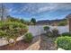 Landscaped backyard with brick pathway and white fence at 8120 Oratorio Pl, Charlotte, NC 28270