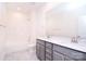 Modern bathroom with a double vanity, gray cabinets, and a bathtub and shower combo at 1364 Cedardale Ln, Denver, NC 28037