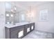 Bathroom features double vanity, tile flooring, glass enclosed shower, and ample light at 1364 Cedardale Ln, Denver, NC 28037