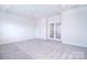 Versatile bonus area with neutral carpet, recessed lights, and double doors, ideal for various uses at 1364 Cedardale Ln, Denver, NC 28037