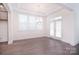 Elegant dining room with a tray ceiling, modern chandelier, and access to the outdoor patio at 1364 Cedardale Ln, Denver, NC 28037