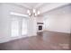 Bright dining room with a modern chandelier and access to the outdoor patio and living room at 1364 Cedardale Ln, Denver, NC 28037