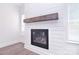 Close up on a modern fireplace with a rustic wood mantle and shiplap surround at 1364 Cedardale Ln, Denver, NC 28037