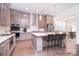 Well-equipped kitchen with stainless steel appliances, a center island with seating, and an adjacent dining area at 1364 Cedardale Ln, Denver, NC 28037