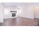 Bright living room with fireplace, large windows, and plenty of open space at 1364 Cedardale Ln, Denver, NC 28037