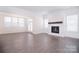 Bright living room features a modern fireplace and large windows, showcasing beautiful natural light at 1364 Cedardale Ln, Denver, NC 28037