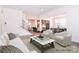Spacious living room with hardwood floors, neutral tones, staircase, and seamless transition to kitchen and dining areas at 1364 Cedardale Ln, Denver, NC 28037