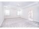 Main bedroom with tray ceiling, neutral carpet, recessed lights, and ensuite bath at 1364 Cedardale Ln, Denver, NC 28037