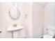 Charming powder room featuring a pedestal sink and modern fixtures at 1364 Cedardale Ln, Denver, NC 28037