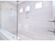 Modern bathroom shower with white tile, bench, mosaic floor, window, and sleek fixtures at 1364 Cedardale Ln, Denver, NC 28037