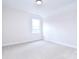 Bright bedroom featuring neutral carpet, trim, and a large window at 1374 Cedardale Ln # 33, Denver, NC 28037