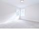 Bright and airy bedroom with neutral carpeting and double windows overlooking the backyard at 1374 Cedardale Ln # 33, Denver, NC 28037
