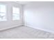 Bedroom featuring neutral carpet, white trim, and two large windows at 1374 Cedardale Ln # 33, Denver, NC 28037