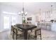 Open dining area with a modern chandelier, dark wood table, and access to the kitchen at 1374 Cedardale Ln # 33, Denver, NC 28037