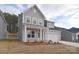 Two-story home featuring a two-car garage, landscaped yard, and covered porch at 1374 Cedardale Ln # 33, Denver, NC 28037