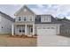 Charming two-story home with a two car garage, manicured lawn and welcoming front porch at 1374 Cedardale Ln # 33, Denver, NC 28037