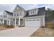 Two-car garage of this two-story home with a paved driveway at 1374 Cedardale Ln # 33, Denver, NC 28037