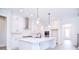 Bright, open kitchen featuring a large island with seating, modern appliances and white cabinets at 1374 Cedardale Ln # 33, Denver, NC 28037