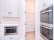 Bright kitchen details: stainless steel appliances, built-in microwave, and pantry with shelving at 1374 Cedardale Ln # 33, Denver, NC 28037