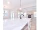 Open-concept kitchen features a large island, stainless steel appliances, and stone fireplace at 1374 Cedardale Ln # 33, Denver, NC 28037