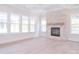 Sunlit living room with fireplace, large windows, and bright interiors at 1374 Cedardale Ln # 33, Denver, NC 28037