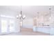 Bright living space with modern chandelier, glass doors to backyard, and open-concept layout at 1374 Cedardale Ln # 33, Denver, NC 28037