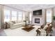 Bright living room with coffered ceiling, fireplace with stone surround, and large windows at 1374 Cedardale Ln # 33, Denver, NC 28037