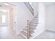 Elegant staircase with wooden steps and wrought iron railings, enhancing the home's interior design at 1374 Cedardale Ln # 33, Denver, NC 28037