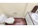 Small half bathroom with pedestal sink and wood-look flooring at 1485 Adkin Dr, Iron Station, NC 28080