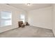 Spacious bedroom with neutral walls, carpet, and large window at 1485 Adkin Dr, Iron Station, NC 28080